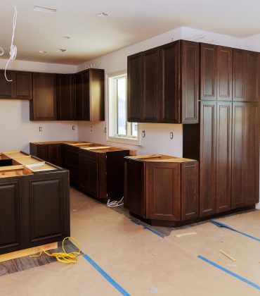 Custom kitchen cabinets in various stages of installation base for island in center